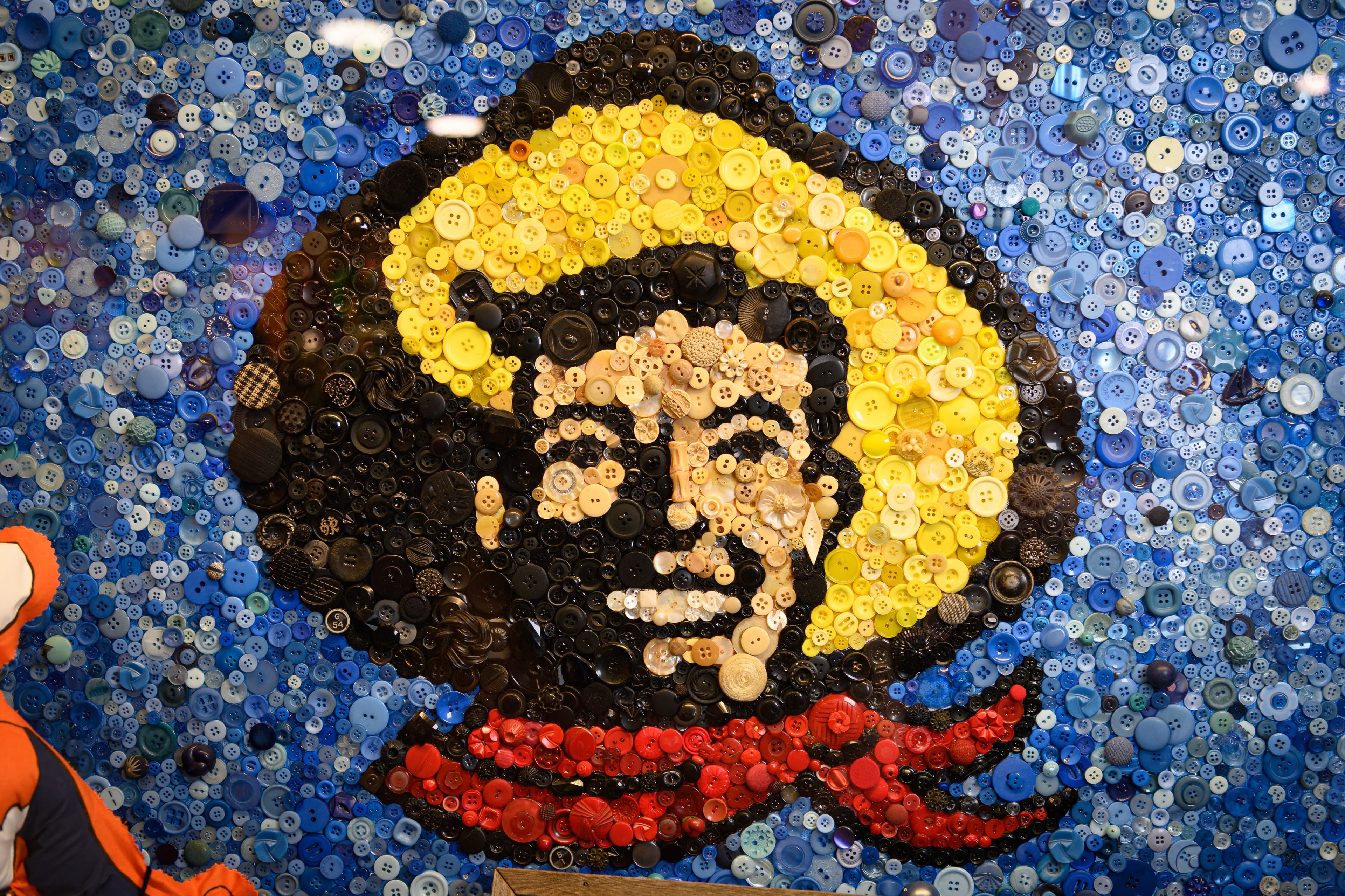 File photo: A cowboy portrait is assembled from multicolored buttons. This earlier fair display does not show the 2026 Hall of State exhibits.